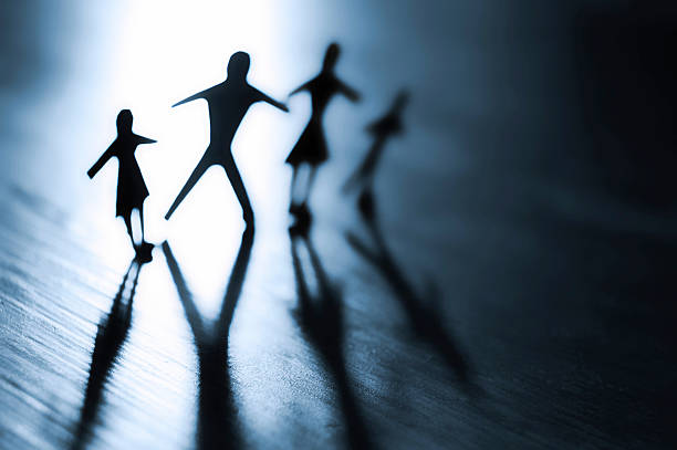 istock Backlit paper family cutouts standing together 93429410