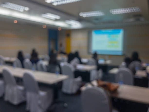 istock abstract blurry of people in seminar room 934296056