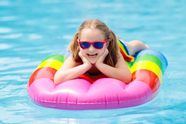 istock Child on inflatable float in swimming pool. 934298278