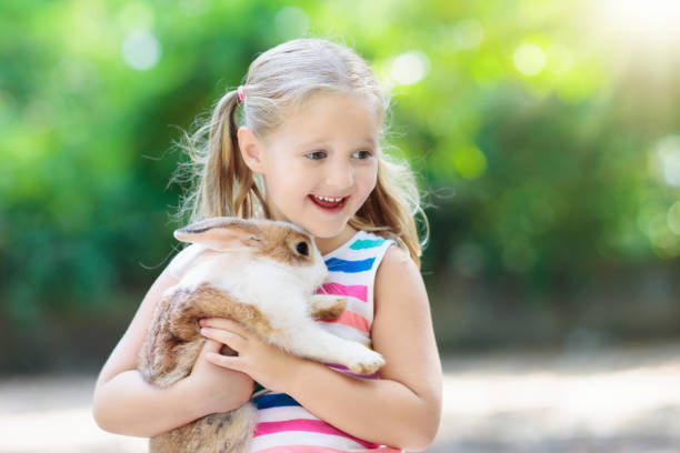 istock Child with rabbit. Easter bunny. Kids and pets. 934301290