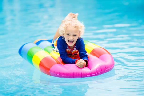 istock Child on inflatable float in swimming pool. 934301704