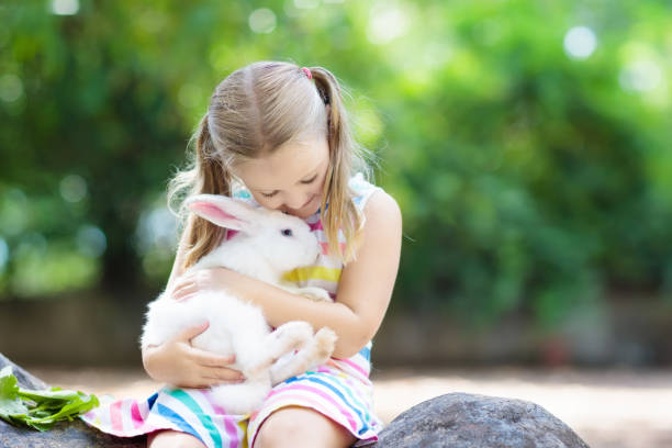 istock Child with rabbit. Easter bunny. Kids and pets. 934303874
