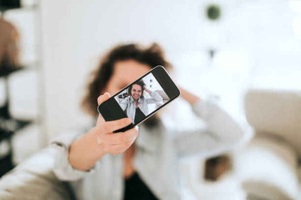 istock Young women doing selfie on sofa 934304198