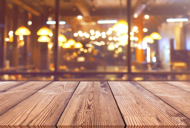 istock Wood table with blur light bokeh in night restaurant 934313736