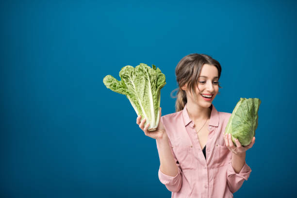 istock Woman with lettuce on the blue background 934319178