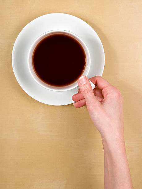 top view female hand holds a cup of coffee stock photo