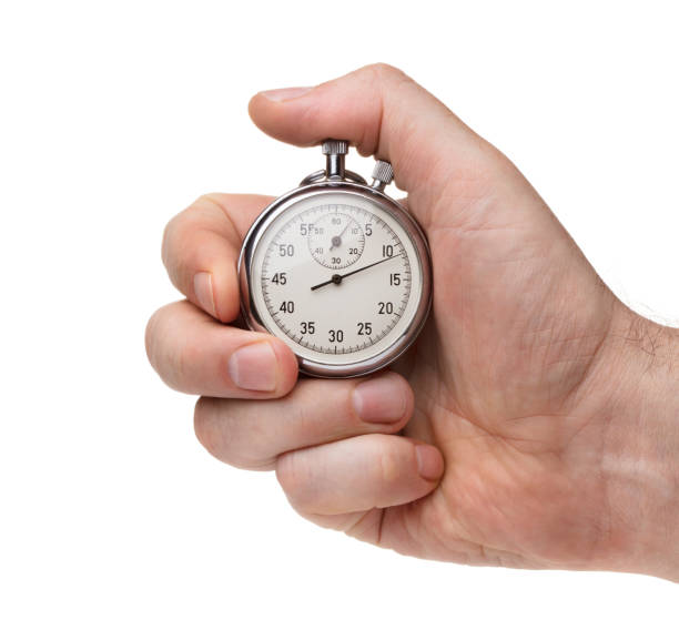 istock Male's hand holding stopwatch isolated on the white background 934330398