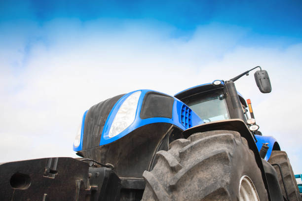 istock Tractor close-up against the sky 934330410