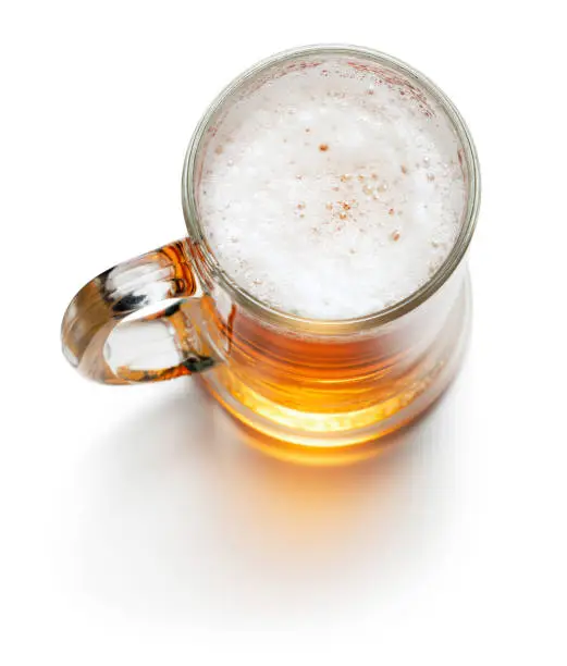 top view of mug of light beer isolated on white background
