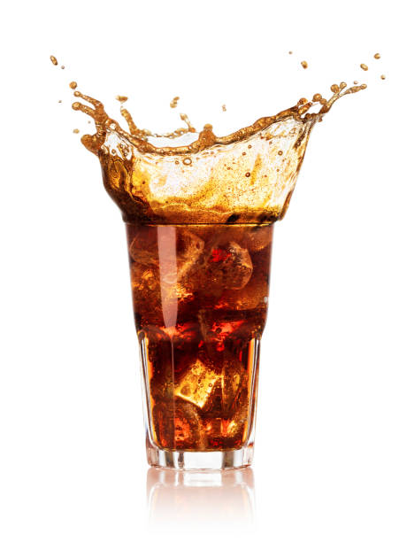 istock glass of cola with splash and drops isolated 934335308