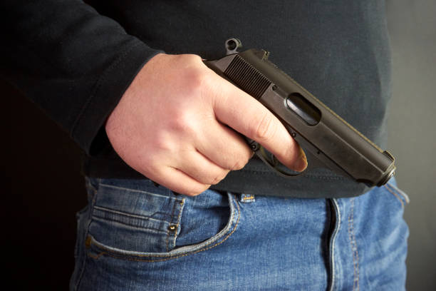 istock The man hid the gun behind their backs, robbery, crime, kidnapping 934336936