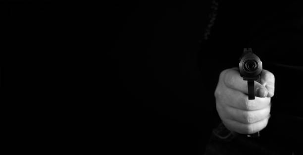 istock a man hand pointing a gun forward black and white photo 934336966
