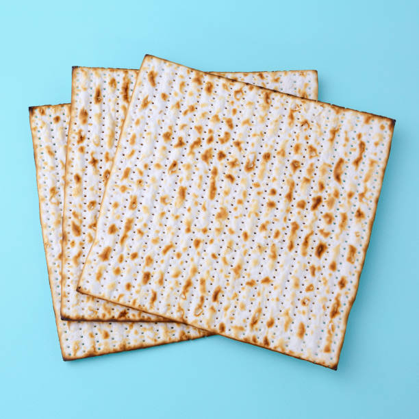 Matzo for Passover celebration Matzo for Passover celebration over blue background. Top view matzo stock pictures, royalty-free photos & images