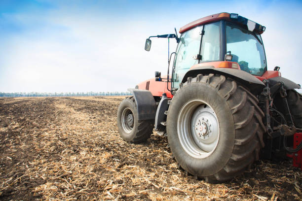 istock Modern red tractor in the field. 934337414