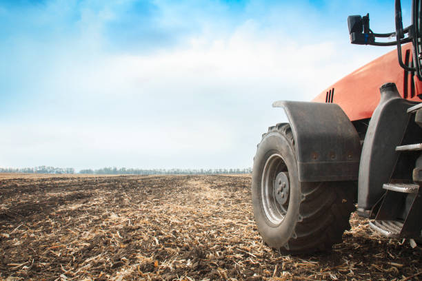 istock Modern red tractor in the field close-up. 934337730