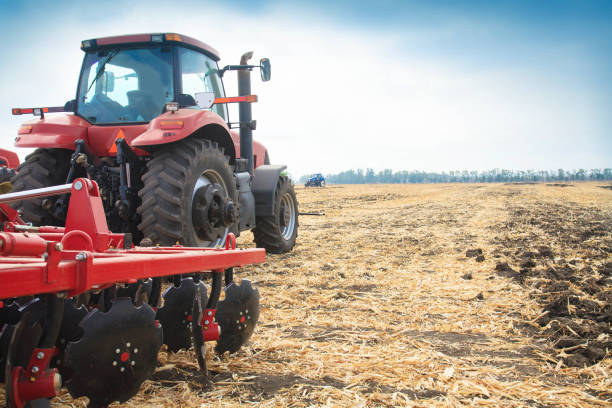 istock Red tractor in the field on a bright sunny day. 934341958