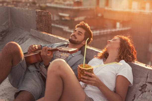 couple at summer rooftop party - love couple city life urban scene imagens e fotografias de stock