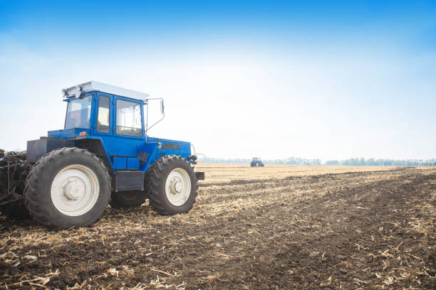 istock Old blue tractor in a empty field. Agricultural machinery, field work. 934354552