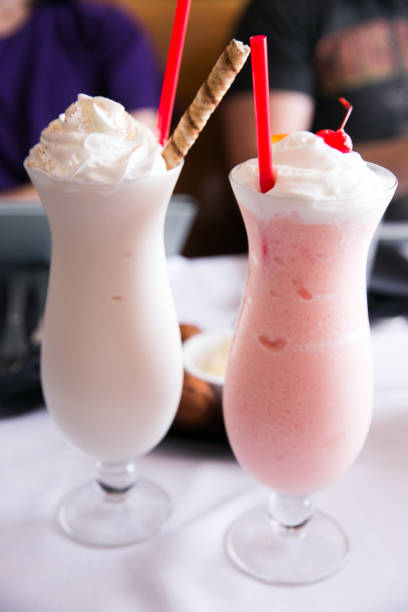 istock Two milkshakes with straws and cherries 934354578