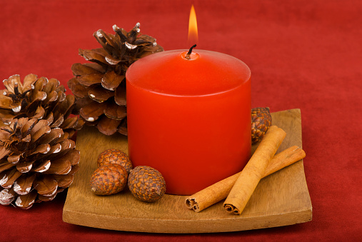 festive candle on a black background with colorful lights
