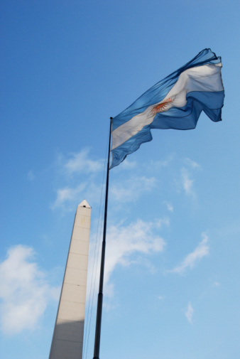 American USA flag on a flagpole waving in the wind. USA Flag Waving United States of America Flag Flying. American flag flying high on a pole against blue sky background on a clear day