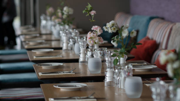 istock Glasses, flower fork, knife served for dinner in restaurant with cozy interior 934397256