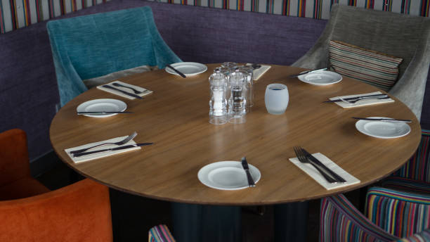 istock Glasses, flower fork, knife served for dinner in restaurant with cozy interior 934398330