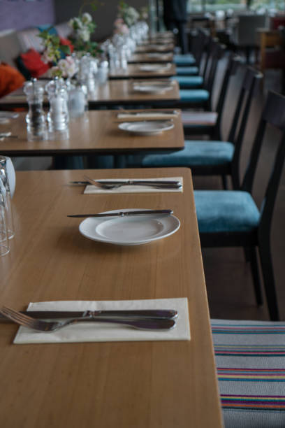 istock Glasses, flower fork, knife served for dinner in restaurant with cozy interior 934398490