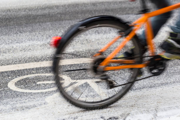 istock Snow-capped bike path and a cyclist 934402878