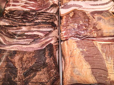 A variety of bacon in a retail display