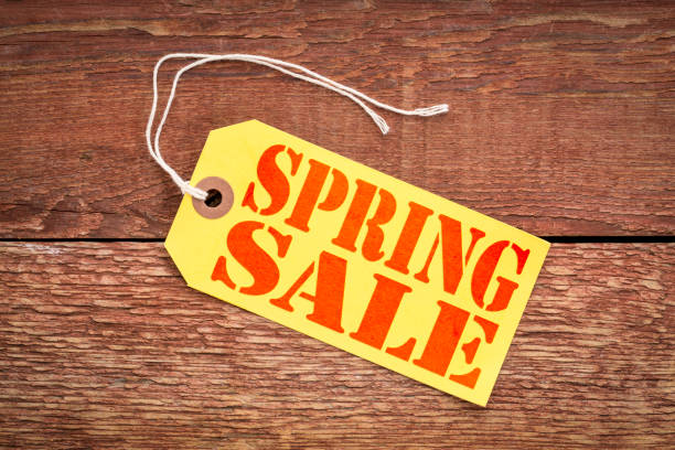 The word March is spelt out in blue lowercase paper letters. The letters are each attached to a metal spring at the bottom of the font. Each letter overlaps and casts a small shadow. The background is plain white.