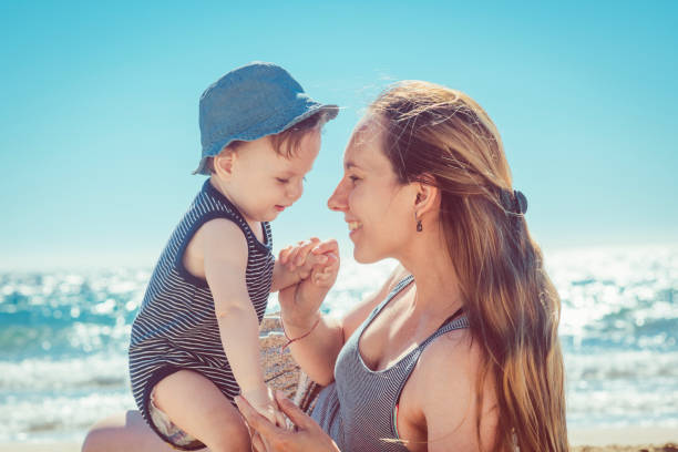 istock Mother and son playing on the beach 934403896