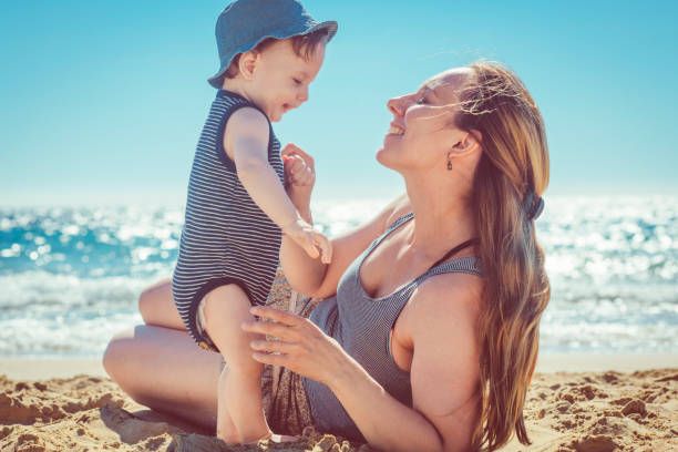istock Mother and son playing on the beach 934403910
