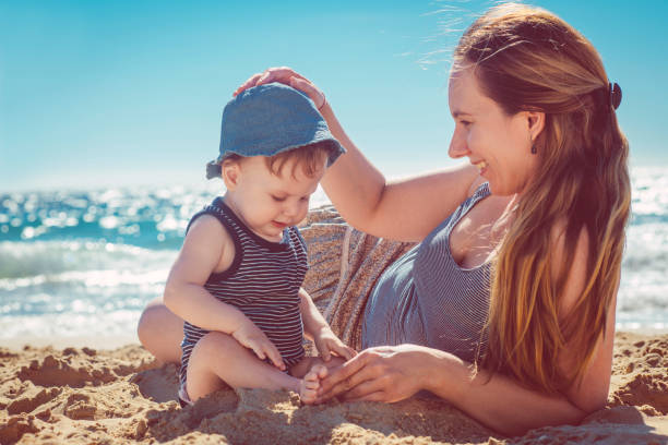istock Mother and son playing on the beach 934404176
