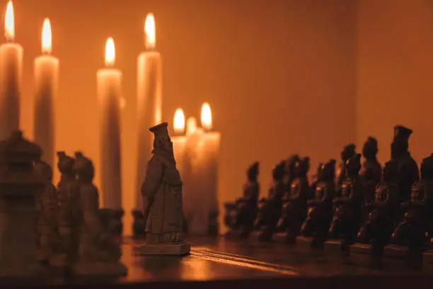 chess board game with candles king is on