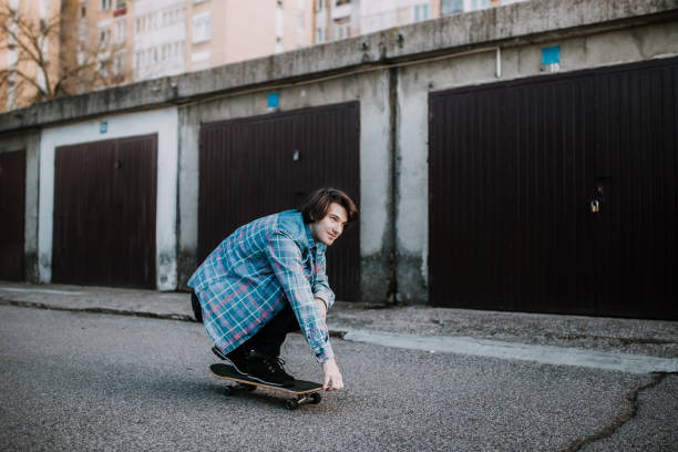 istock Man riding skateboard on parking lot 934408428