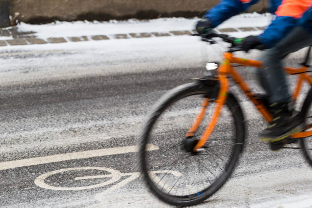 istock A snow-capped bike path and a partial view of a cyclist 934411592
