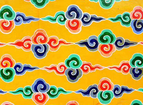 A colorful piece of fabric with a floral pattern. The colors are bright and the design is intricate