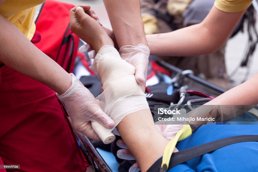 First aid. Hand bandaging. First aid training Care Stock Photo