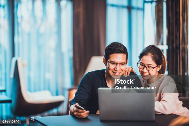 Young Asian Married Couple Working Together Using Laptop At Home Or Modern Office With Copy Space Startup Family Business Sme Entrepreneur Business Partner Love Relationship Or Freelance Concept Stock Photo - Download Image Now