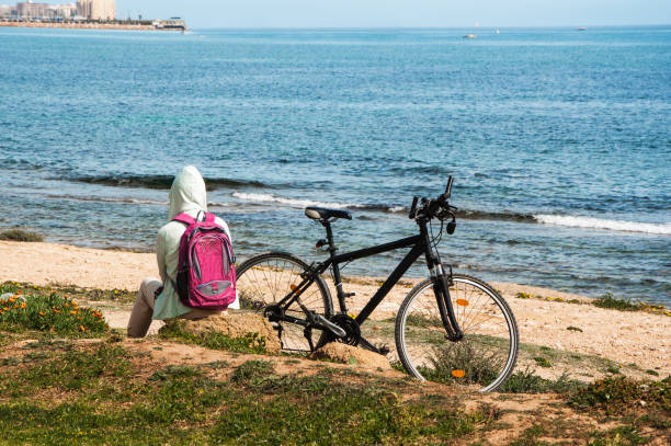 istock Young tourist spends time on winter seaside 934422532