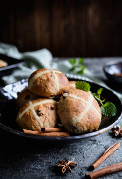 istock Hot Cross Buns - Easter sweet spiced pies with raisins 934428348