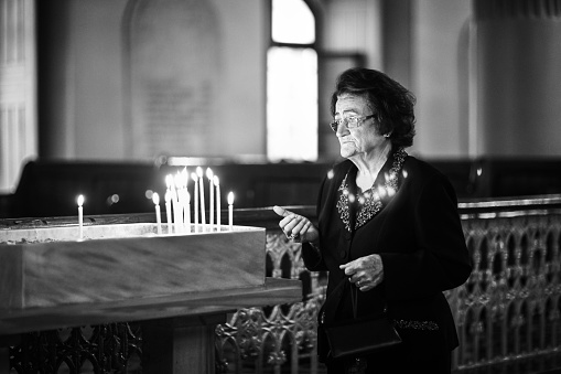 Istanbul, Turkey, October 11, 2015: Old woman is praying in church. This is the Crimean Church in Istanbul