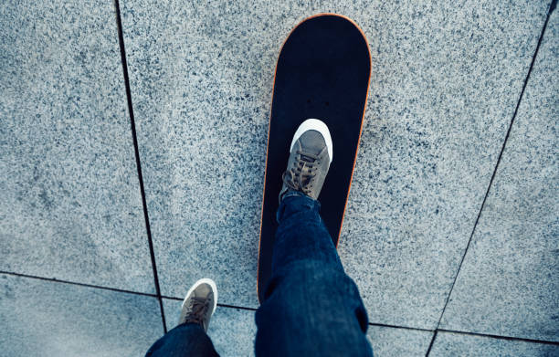 istock female skateboarder riding with skateboard on city 934439652