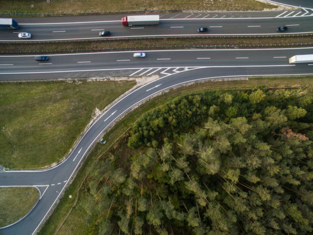 istock Aerial view of a highway amid fields with cars on it 934441444
