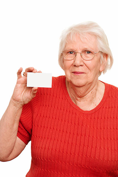 senior publicidade - glasses holding business card imagens e fotografias de stock