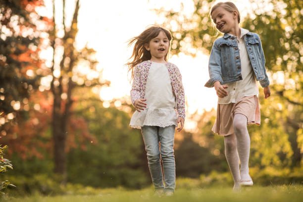 istock Two cute girls walking together in nature 934475406