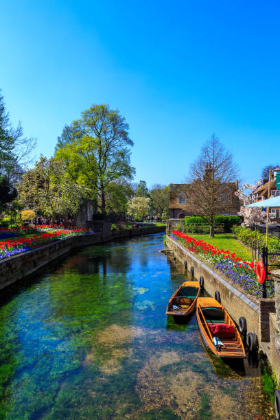 Canterbury Canal Canterbury, England - A shot looking up one of the canals of Canterbury.  You can see the famous punting boats which are very popular with tourists visiting the area. canterbury england photos stock pictures, royalty-free photos & images