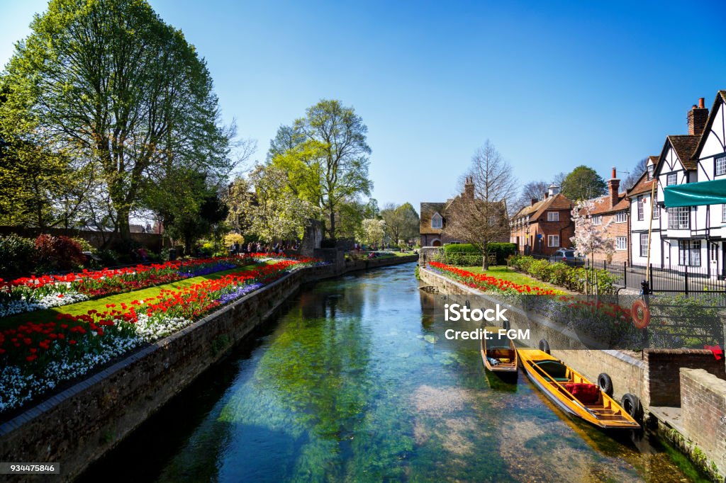 Canterbury Canal Canterbury, England - A shot looking up one of the many beautiful canals of Canterbury.  This city can be found in the South East of England and is extremely popular with tourists from all over the world.  Tourists can take punting tours on the canal. Canterbury - England Stock Photo