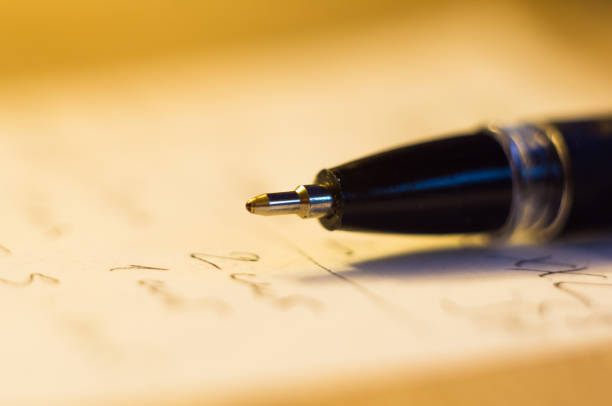 istock ball point pen and a sheet of paper 934480608